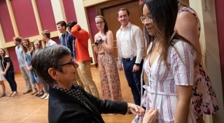 New member of Phi Beta Kappa receives cord from Professor Nadia Marano
