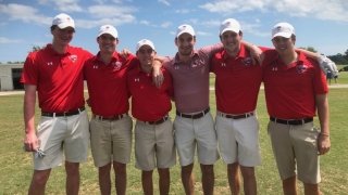 Six members of the Saint Lawrence University men's golf team. They all wear red golf shirts and khaki shorts.