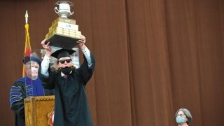 A student raises up a trophy during the Commencement celebrations for the class of 2021