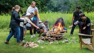 students around a Viking style funeral pyre