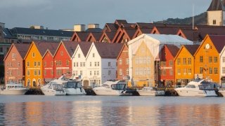 Colorful orange and red buildings along the seaside in a coastal town in Denmark.