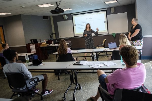 President Morris in a classroom presenting to a group of people