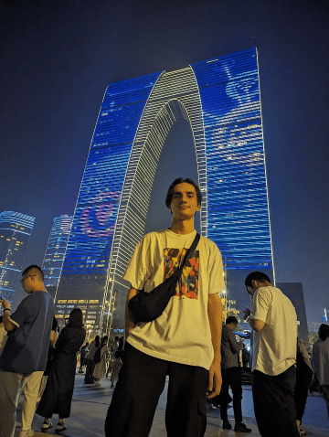 Student standing in Suzhou at night 