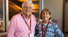 Bill and Jane Christ wearing scarlet and brown lanyards. 