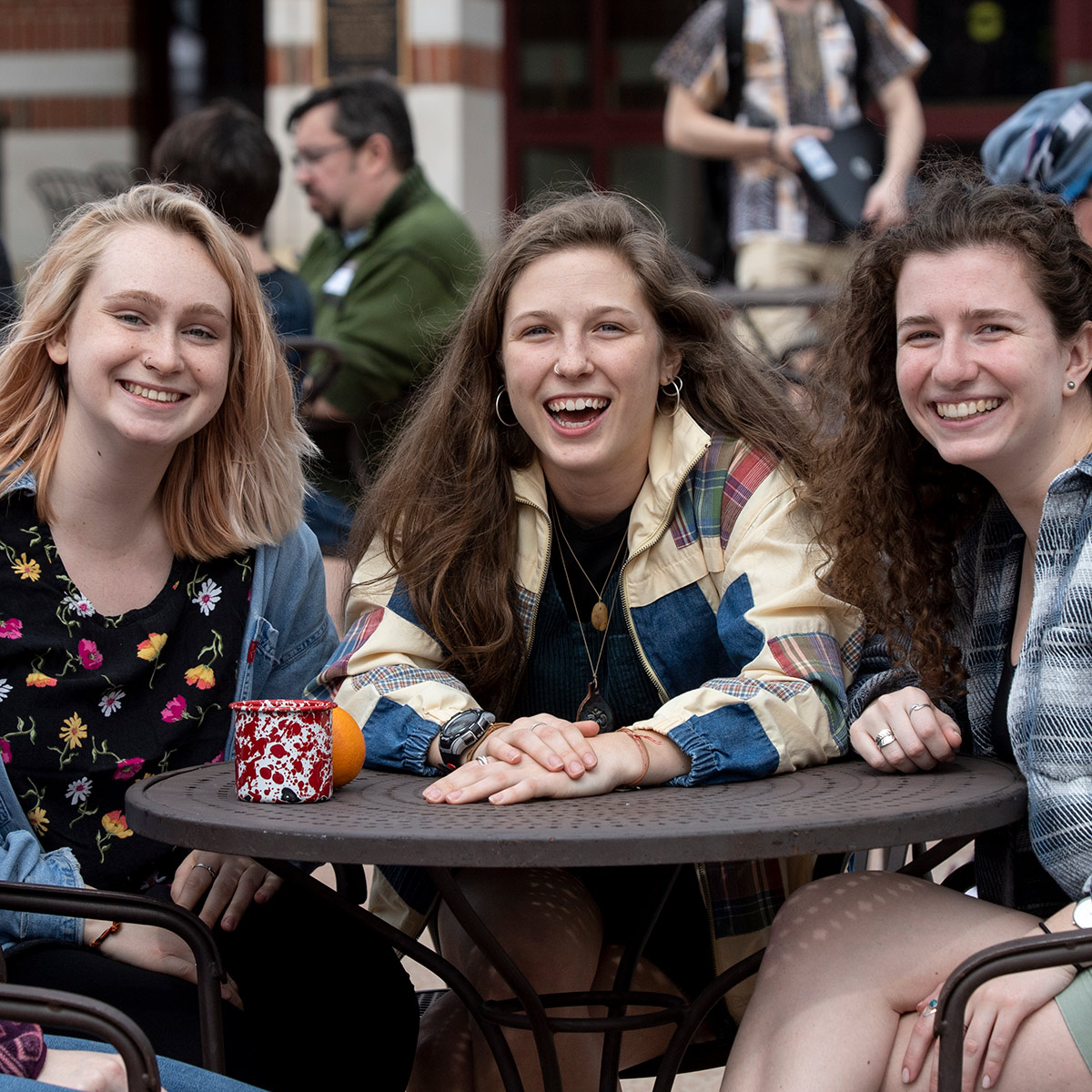 Three Laurentians sitting at a table outside