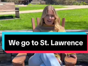 A person sits outdoors in a wooden chair on a sunny day with green grass in the background. Text overlay reads, "We go to St. Lawrence."