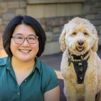 Asian woman wearing glasses with dog