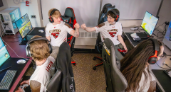 Saint Lawrence University esports athletes fist-bumping after a win