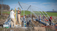 Students helping construct St. Lawrence University's greenhouse on the living laboratory
