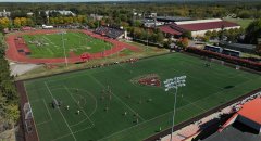 Alt text: Aerial view of St. Lawrence University's athletic complex, with soccer and football games taking place simultaneously on adjacent fields during a sunny fall day.