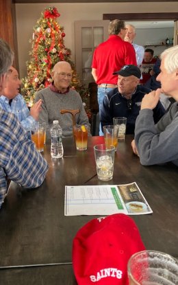 Coach Leet at a table surrounded by Laurentians.