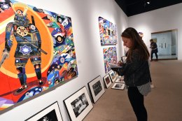 student examining artwork in the gallery