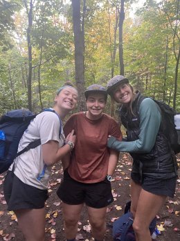 Sage and Ryann warming their hands with Cara’s body heat.