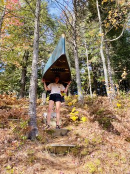 Sage carries the canoe beneath the autumn colors.