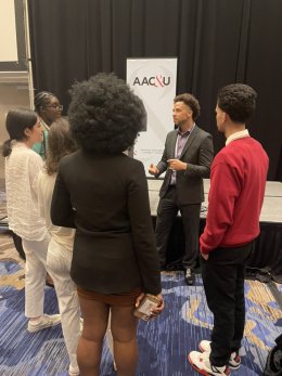 A group of Saint Lawrence students listen to a speaker at the American Association of Colleges &amp; Universities Conference on Diversity, Equity, and Student Success.