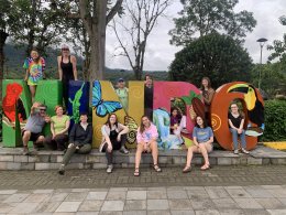 Students posing around Mindo sign