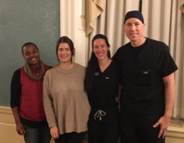 four physians posing for picture