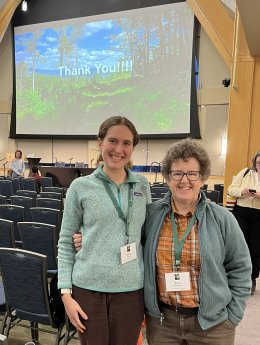 two females at conference smiling for picture