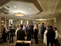 Students and Alumni network in a formal gathering space.