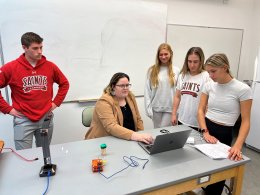 instructor with students standing around