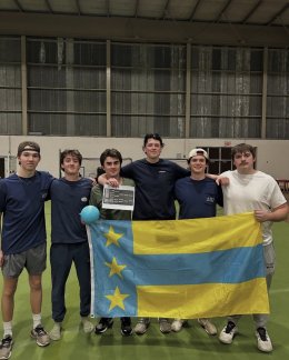 ATO members holding their chapter flag at their annual dodgeball philanthropy event