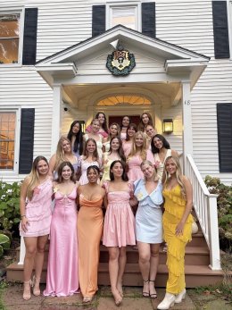 Chi Omega Members on front steps of their house