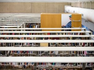 A student sits in a large &quot;treehouse&quot; cubicle elevated among the stacks of books in a library.