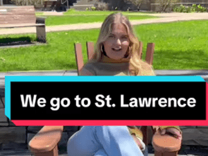 A person sits outdoors in a wooden chair on a sunny day with green grass in the background. Text overlay reads, &quot;We go to St. Lawrence.&quot;