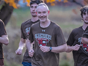 Paul Graham runs outside with the Saints Men's Cross Country team.