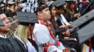 Commencement including Native American in traditional clothing