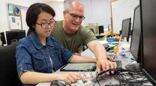 Faculty member working with student on computer