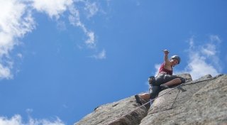 A student rock climbing during an off-campus trip.