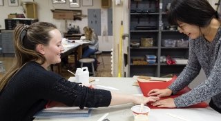 2 students engaging in sophomore seminar activities in art studio.