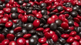 Up-close with a lot of red and brown M and Ms.