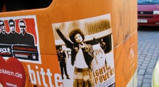 street photograph of sticker -- woman making a fist