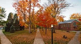 St. Lawrence campus on a Fall day, with three paths diverging from the center.
