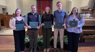 MUD award recipients smiling with certs