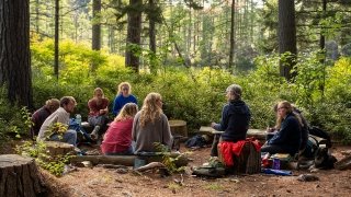 Faculty member teaching class in the woods