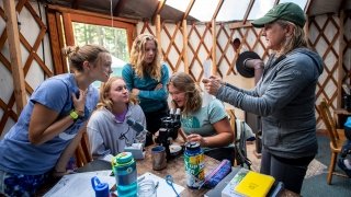 Students and faculty member in class in yurt
