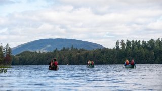 People canoeing on a lake