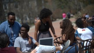 Hana Bushara laughs with a group of Saint Lawrence friends on campus. 