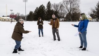 Faculty member doing experiment with students in the snow