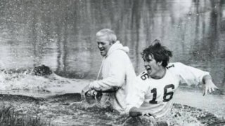 Coach Leet and player in water.