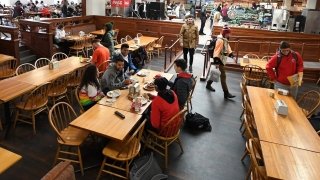 A group of Saint Lawrence students engaged in animated discussion at a large rectangular dining table. Photo from January 2020.