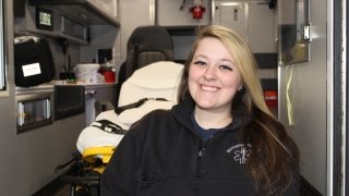 Emily Cafarella sits in the back of an ambulance where she serves as a member of the Massena Rescue Squad.