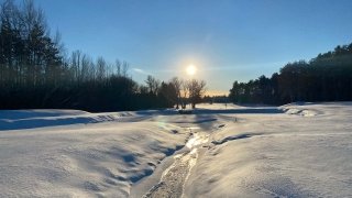 The sun rises over a snow-covered golf course on the Saint Lawrence University campus.
