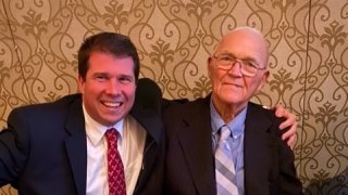Mike Mahoney and Don Leet shoulder to shoulder at a table.
