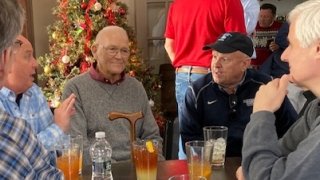 Coach Leet at a table surrounded by Laurentians.