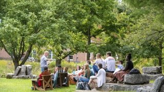 A Saint Lawrence University professor teaches a class outside.