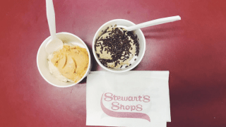Two cups of ice cream, on a table, with a napkin that reads, "Stewart's Shops."